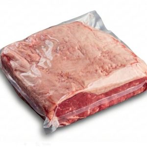Whole raw beef striploin porterhouse in vacuum sealed cryovac packaging on white background